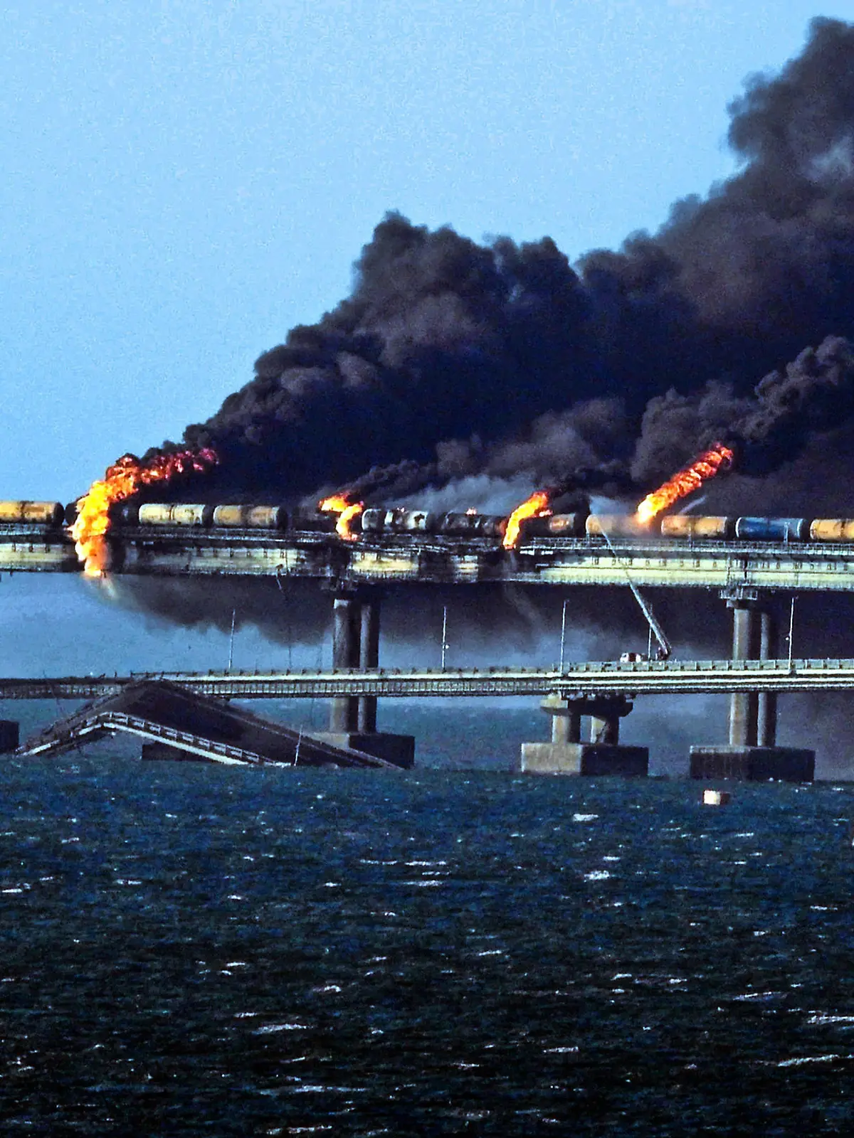 Black smoke billows from a fire on the Kerch bridge that links Crimea to Russia, after a truck exploded, near Kerch, on Saturday on October 8, 2022. Moscow announced that a truck exploded igniting a huge fire and damaging the key Kerch bridge built as Russia's sole land link with annexed Crimea. photo by Vladimir Mordunov/UPI. Photo via Newscom/upiphotostwo886621/UPI/Newscom/SIPA/2210082225