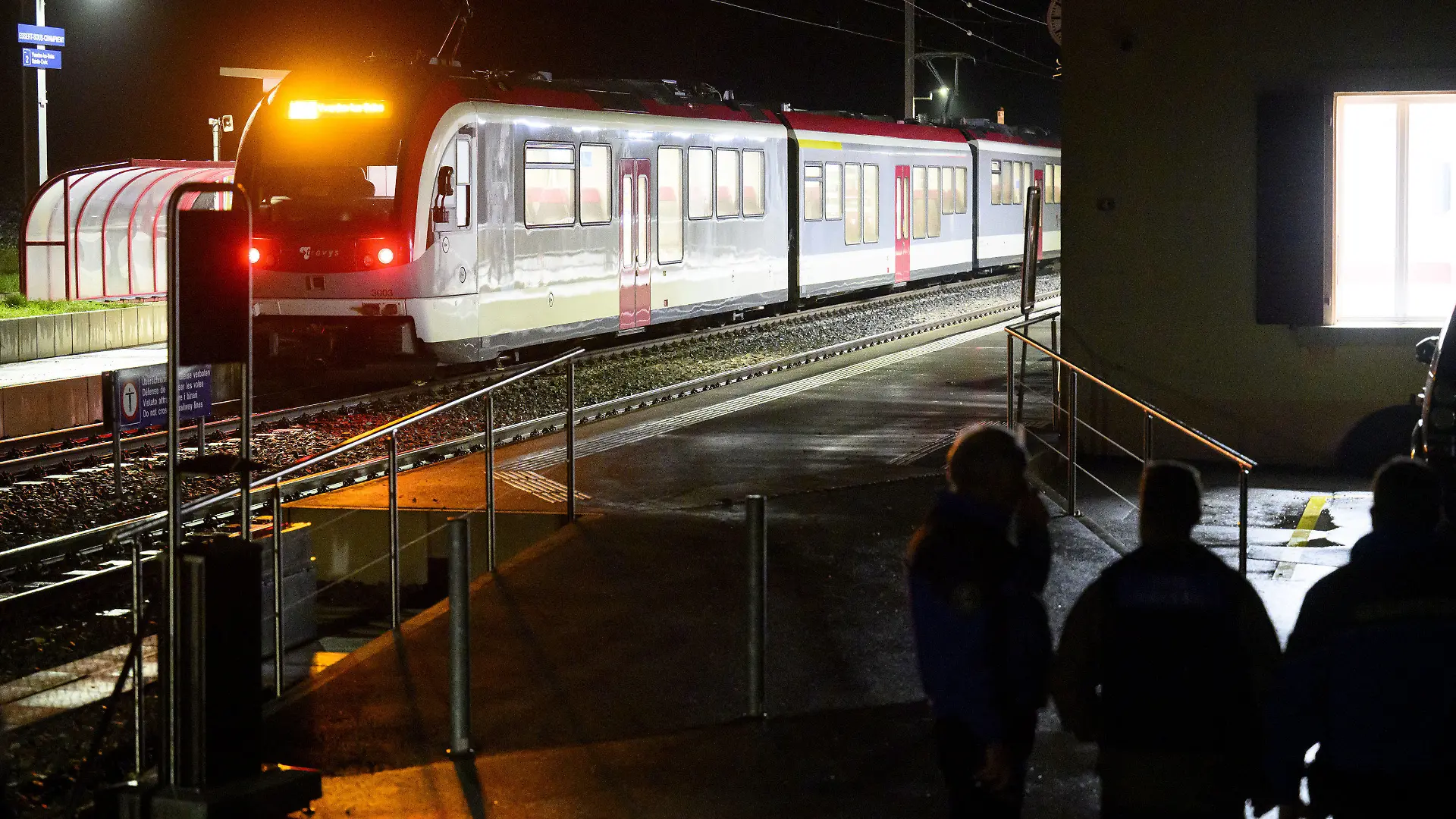 08.02.2024, Schweiz, Essert-Sous-Champvent: Waadtländer Kantonspolizisten bewachen den Travys-Zug, in dem sich eine Geiselnahme ereignet hat. In der Schweiz ist es am Donnerstag in einem Regionalzug zu einer Geiselnahme gekommen. Nach Angaben der Polizei konnten alle Geiseln befreit werden und waren wohlauf. Der Zwischenfall ereignete sich in der Westschweiz zwischen Yverdon und Sainte-Croix. Foto: Laurent Gillieron/KEYSTONE/dpa +++ dpa-Bildfunk +++