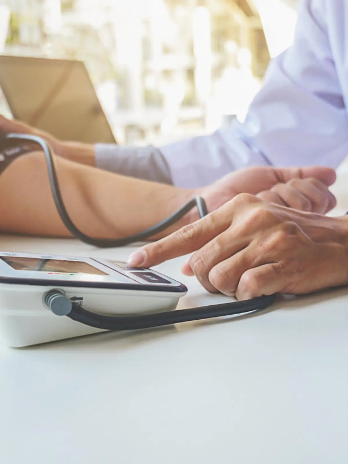 healthcare, hospital and medicine concept - doctor and patient measuring blood pressure.