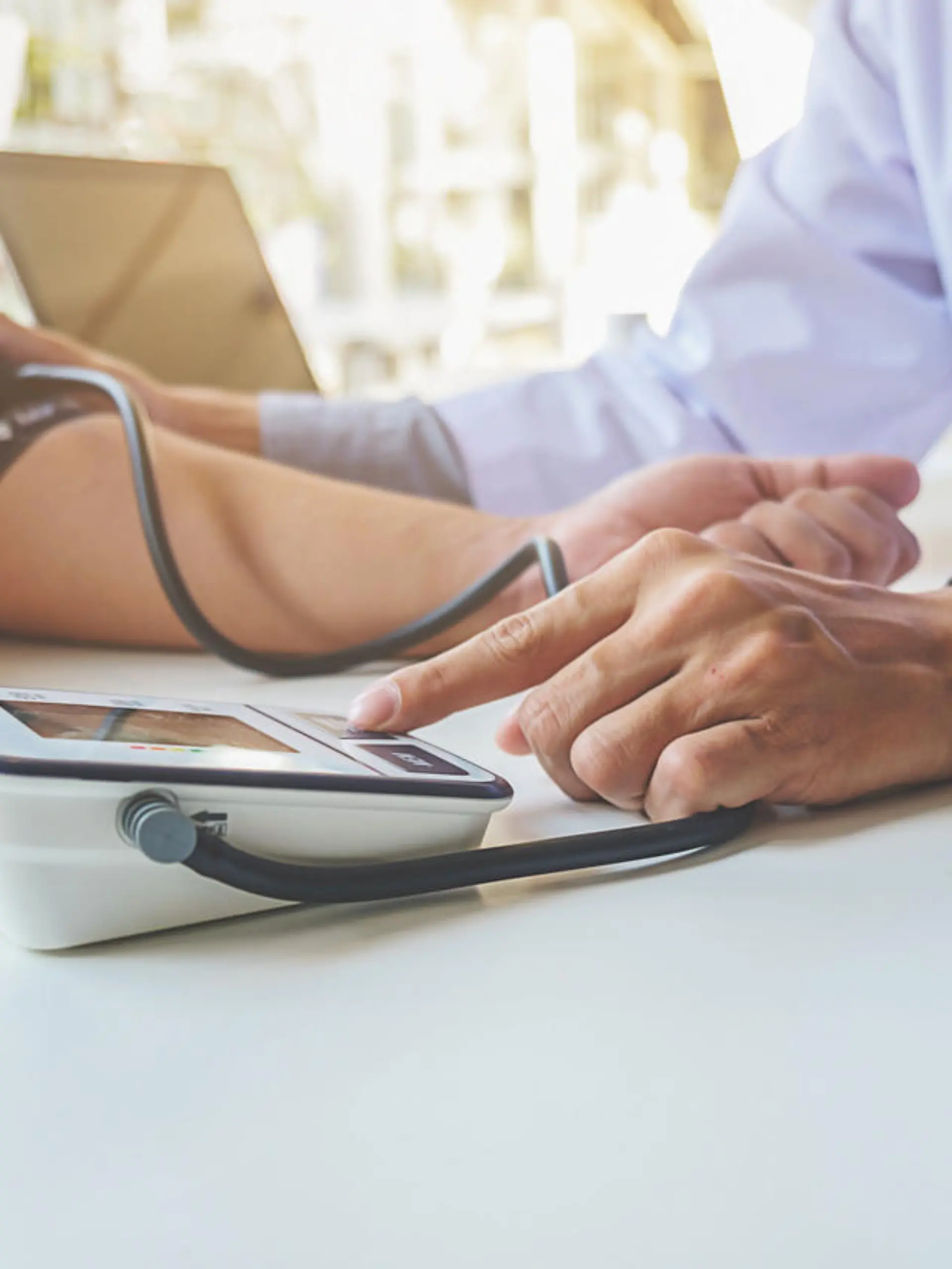 healthcare, hospital and medicine concept - doctor and patient measuring blood pressure.