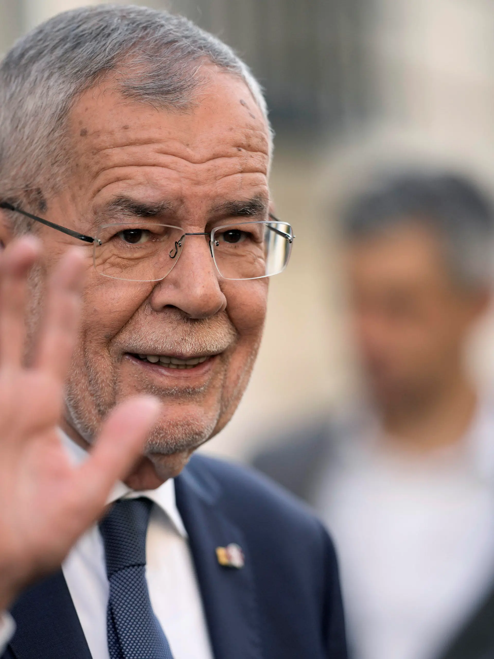 Austrian President Alexander Van der Bellen waves after casting his vote for the Austrian Presidential election in Vienna, Austria, Sunday, Oct. 9, 2022. Austria's liberal president is hoping to be re-elected on Sunday without the need for a runoff vote after a campaign in which he has cast himself as the stable option in uncertain times. (AP Photo/Markus Schreiber)