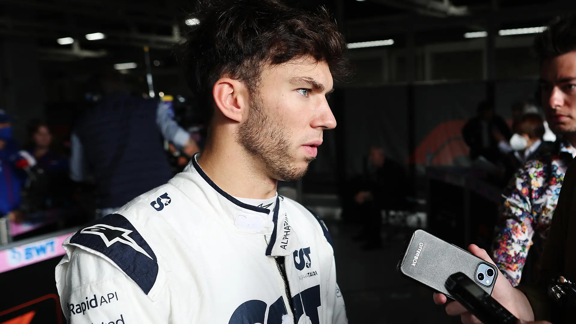 SUZUKA, JAPAN - OCTOBER 08: Seventeenth placed qualifier Pierre Gasly of France and Scuderia AlphaTauri talks to the media in the Paddock during qualifying ahead of the F1 Grand Prix of Japan at Suzuka International Racing Course on October 08, 2022 in Suzuka, Japan. (Photo by Peter Fox/Getty Images )