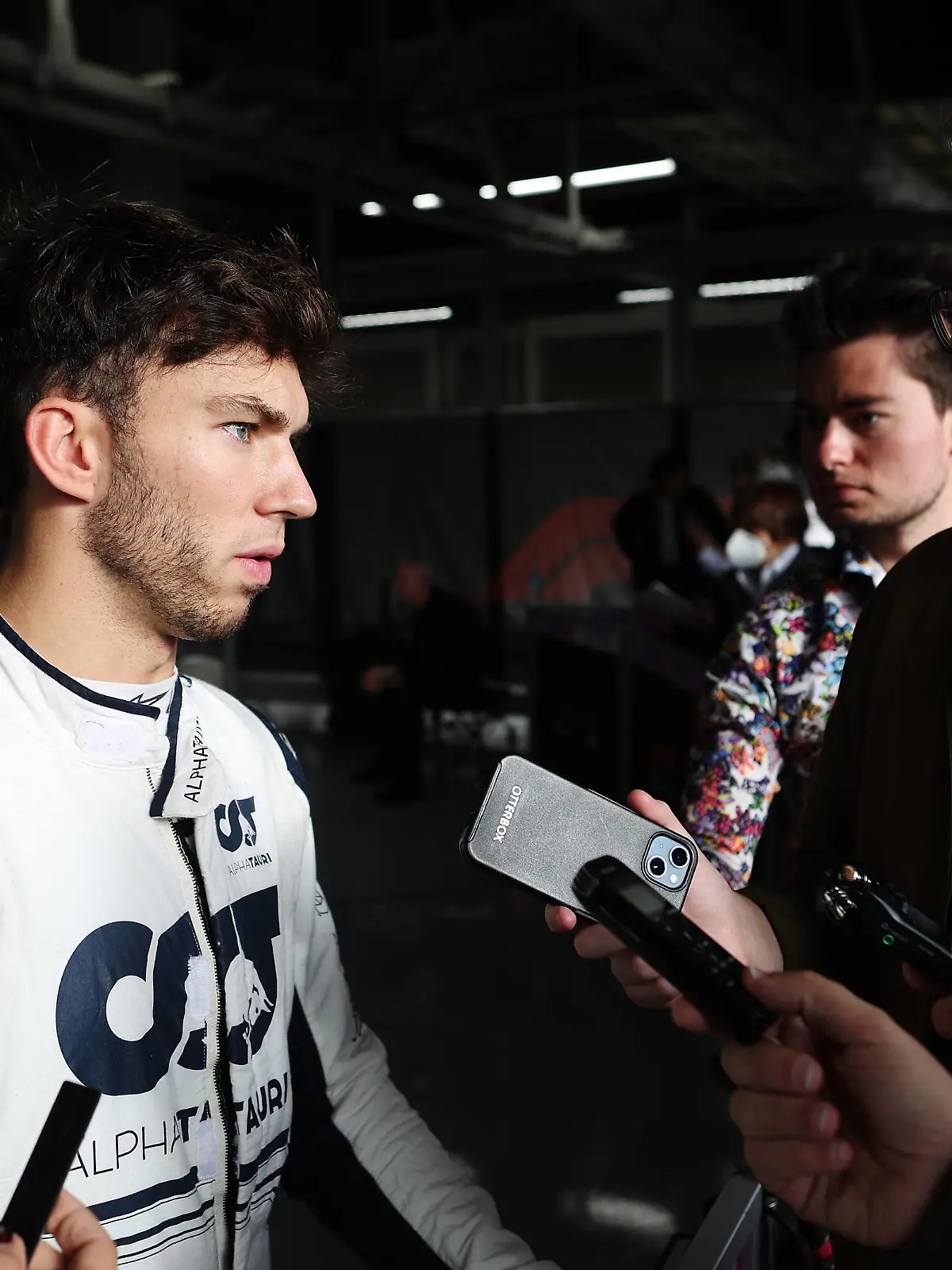 SUZUKA, JAPAN - OCTOBER 08: Seventeenth placed qualifier Pierre Gasly of France and Scuderia AlphaTauri talks to the media in the Paddock during qualifying ahead of the F1 Grand Prix of Japan at Suzuka International Racing Course on October 08, 2022 in Suzuka, Japan. (Photo by Peter Fox/Getty Images )
