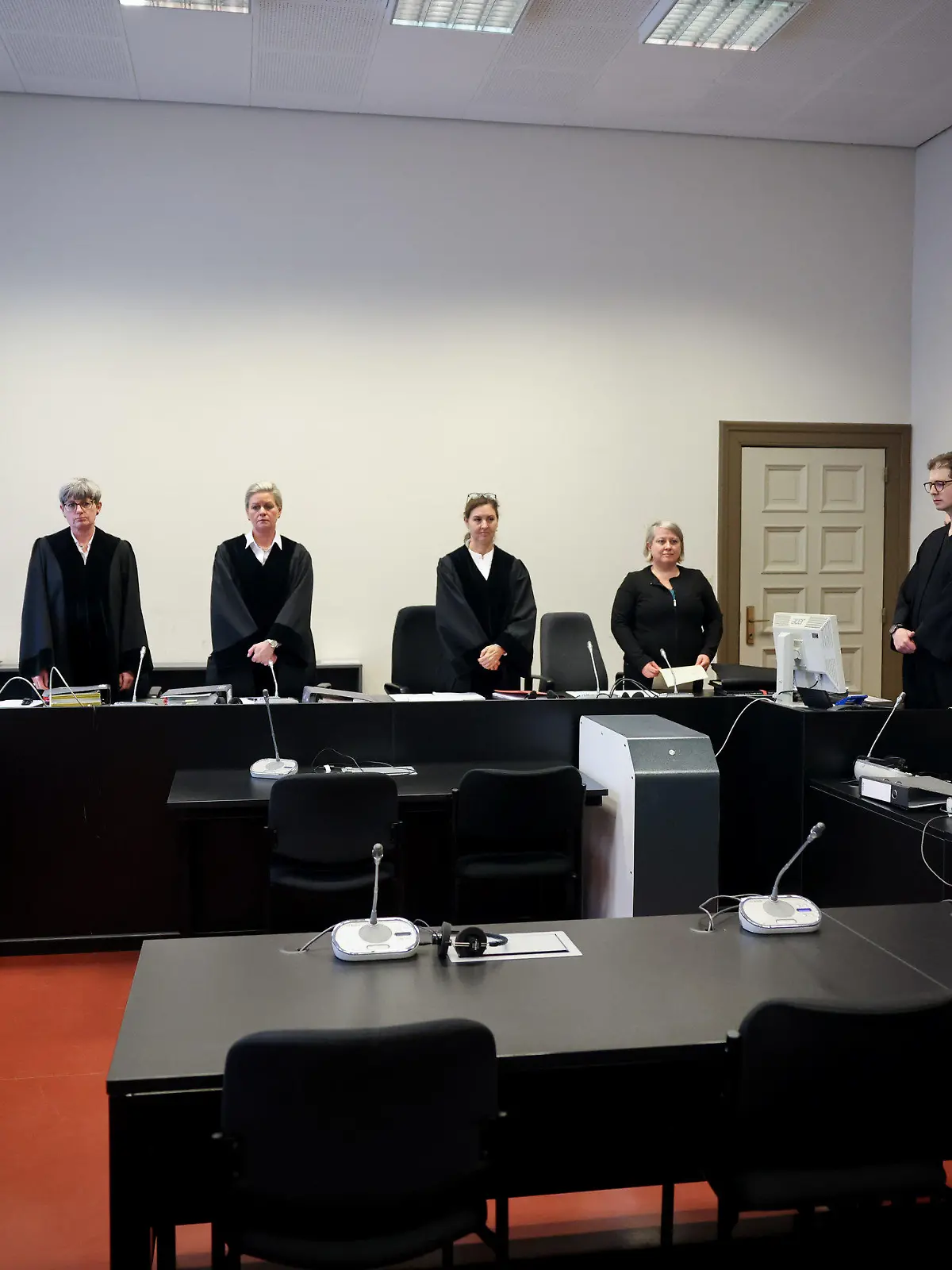 13.02.2024, Hamburg: Jessica Koerner (4.v.l), Vorsitzende Richterin am Landgericht, Anwalt Christian Lange (r) neben dem noch leeren Platz seiner Mandantin sowie weitere Prozessbeteiligte stehen zu Beginn eines Prozesses im Gerichtssaal im Strafjustizgebäude. Eine 33-Jährige muss sich von Dienstag an wegen Totschlags, versuchten Mordes und gefährlicher Körperverletzung vor dem Landgericht Hamburg verantworten. Foto: Christian Charisius/dpa +++ dpa-Bildfunk +++