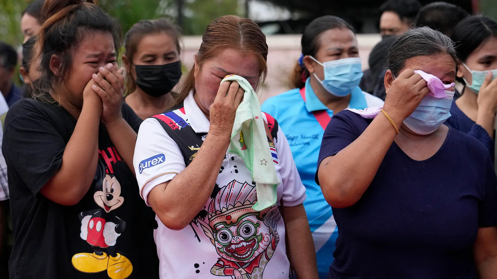 Relatives and friends mourn during a ceremony for those killed in the attack on the Young Children's Development Center in the rural town of Uthai Sawan, north eastern Thailand, Friday, Oct. 7, 2022. A former policeman facing a drug charge burst into a day care center in northeastern Thailand on Thursday, killing dozens of preschoolers and teachers before shooting more people as he fled in the deadliest rampage in the nation's history. (AP Photo/Sakchai Lalit)