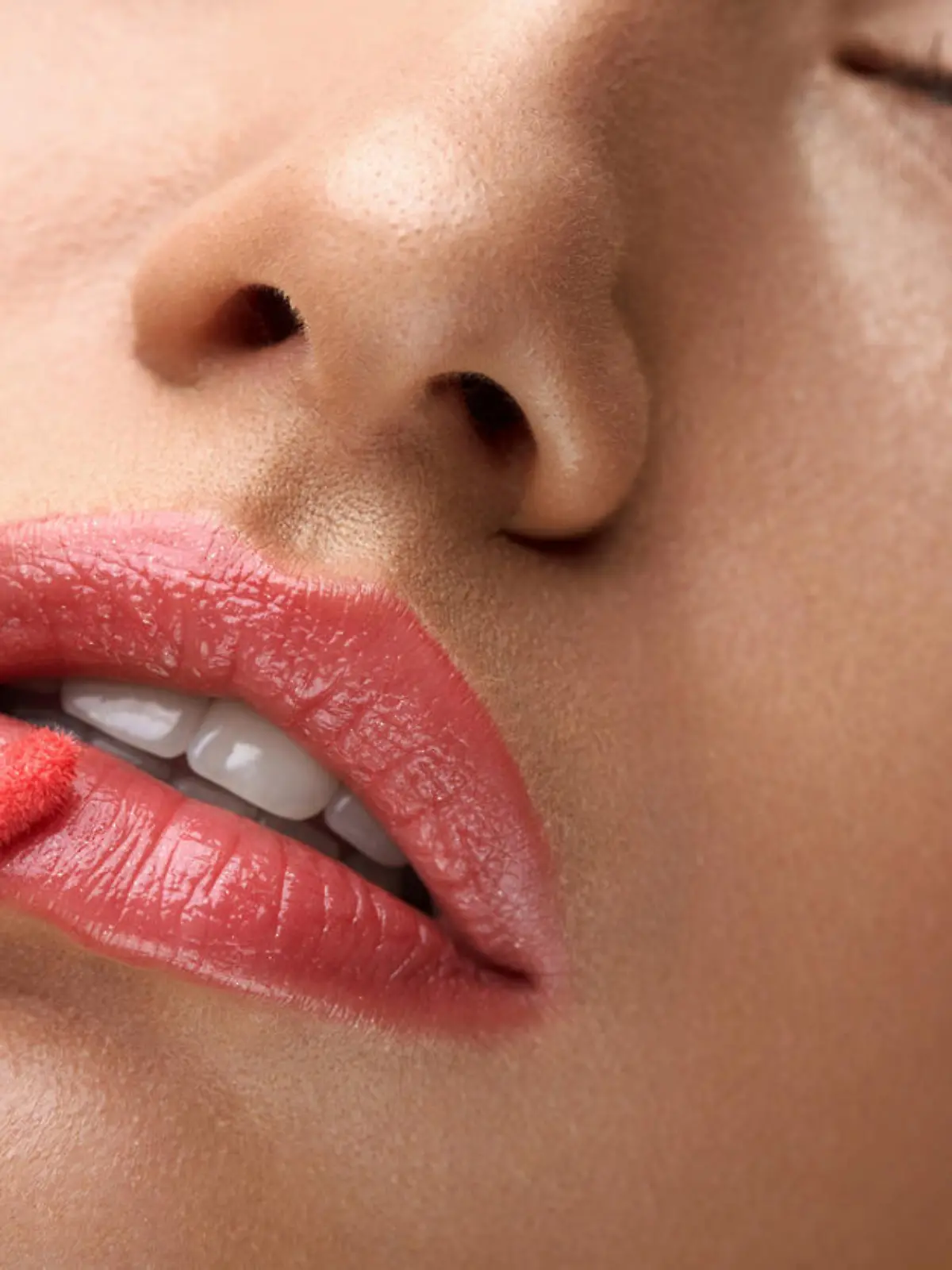 Beauty Makeup. Closeup Of Beautiful Woman Face With Smooth Skin, Soft Plump Full Lips With Lip Gloss On. Close-up Of Girl Applies Liquid Lipstick Or Lip Balm, Lip Care Cosmetics. High Resolution Image