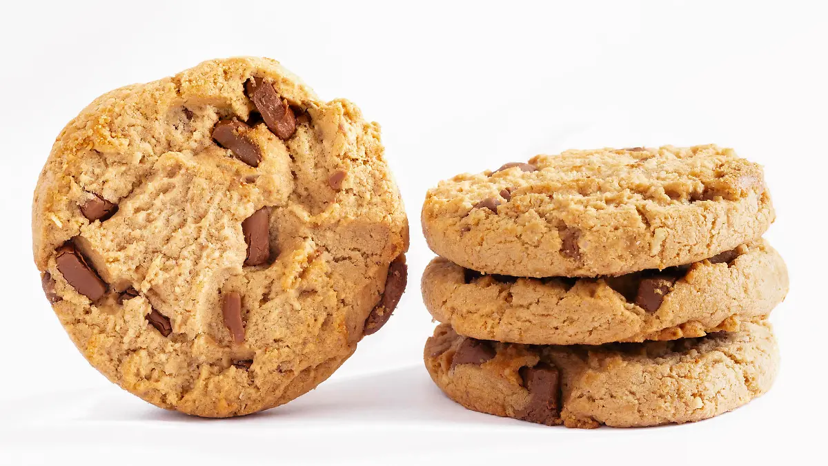 Chocolate chip cookies stacked on white background.