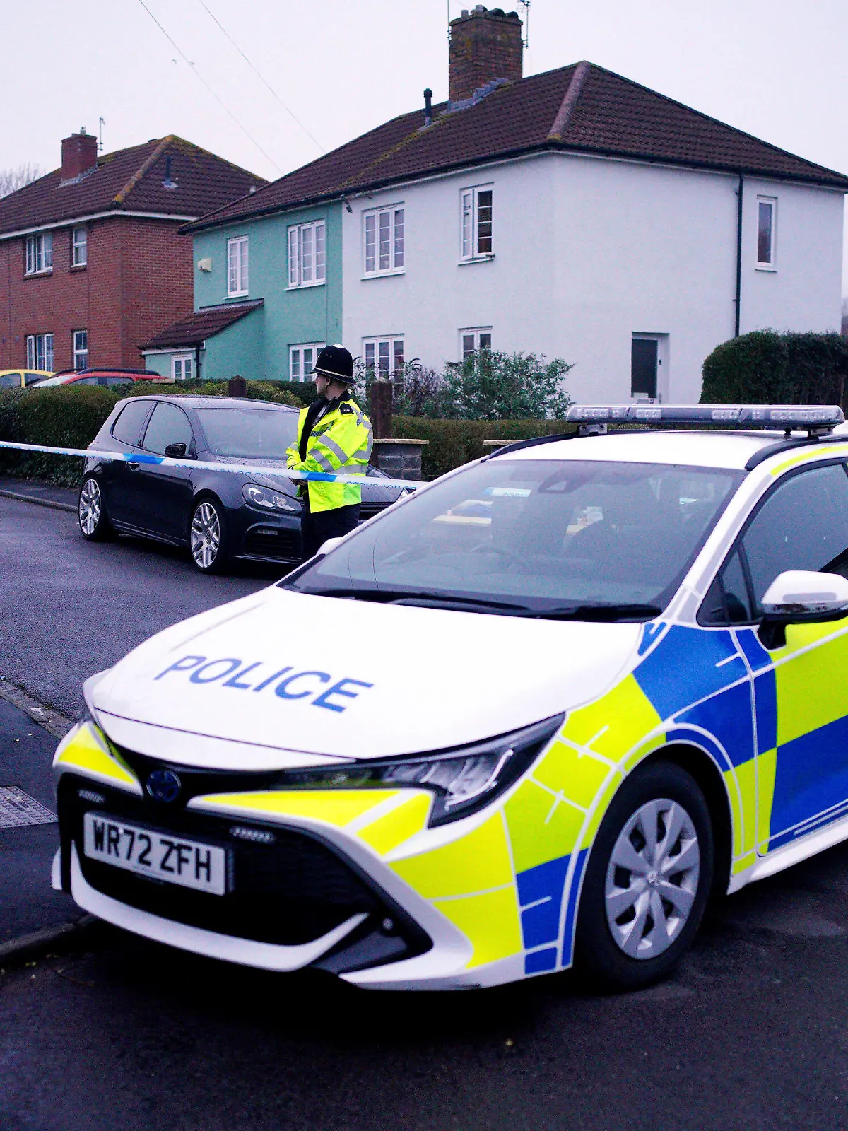 Police work at the scene in Blaise Walk, in Sea Mills, Bristol, England, where a woman has been arrested on suspicion of murder after three children were found dead at a property, Sunday, Feb. 18, 2024. he Avon and Somerset Police force said officers were called to a house in the Sea Mills area of Bristol shortly after midnight and found the three children inside. It said a 42-year-old woman is in police custody at a hospital. (Ben Birchall/PA via AP)