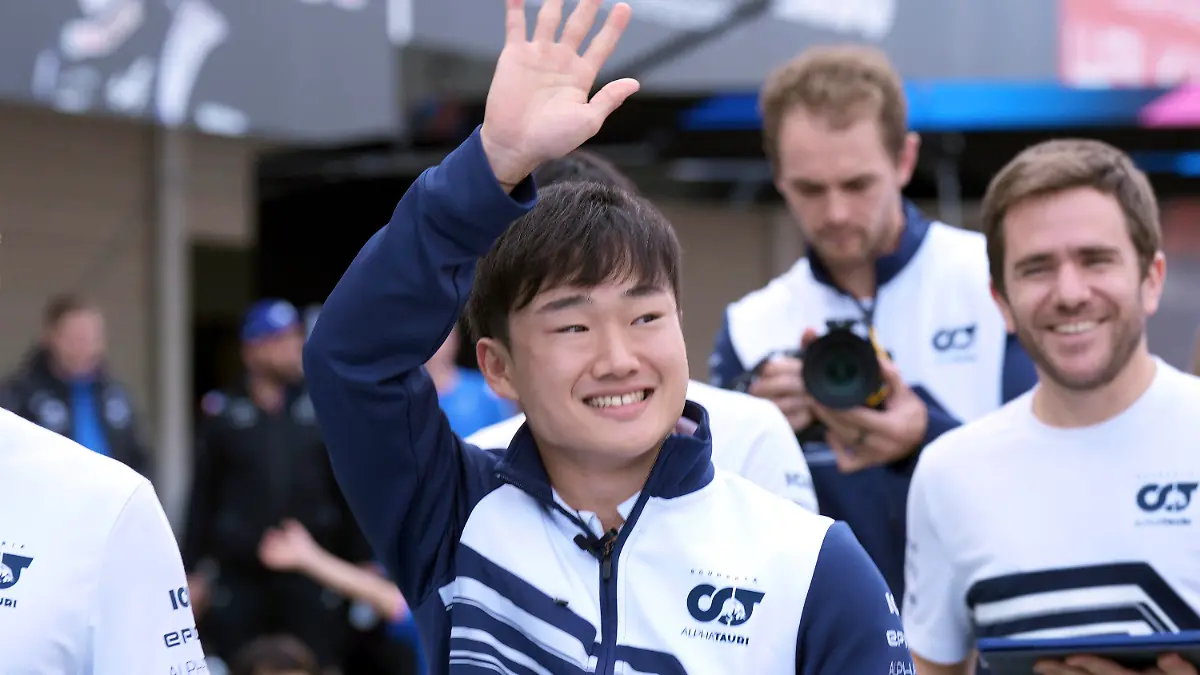 AlphaTauri driver Yuki Tsunoda of Japan waves to his fans at the pit lane before the Japanese Formula One Grand Prix at the Suzuka Circuit in Suzuka, central Japan, Thursday, Oct. 6, 2022. (AP Photo/Eugene Hoshiko)