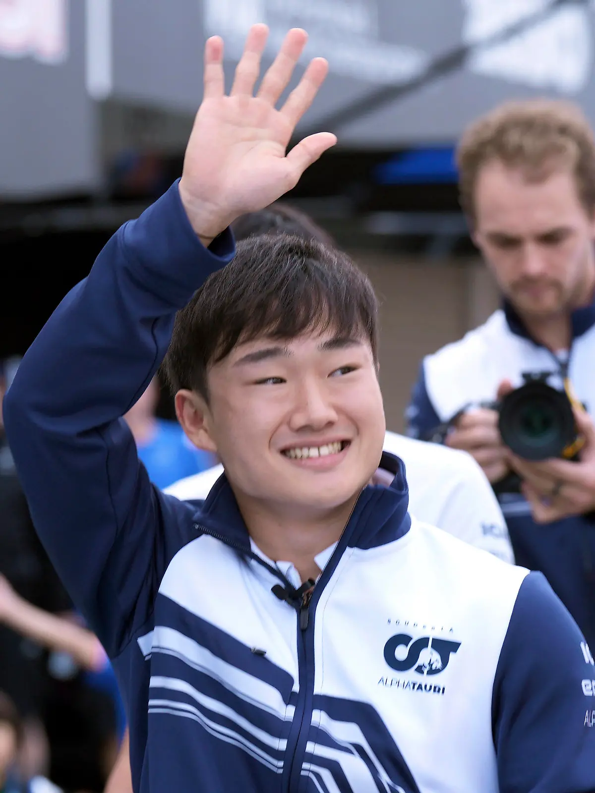 AlphaTauri driver Yuki Tsunoda of Japan waves to his fans at the pit lane before the Japanese Formula One Grand Prix at the Suzuka Circuit in Suzuka, central Japan, Thursday, Oct. 6, 2022. (AP Photo/Eugene Hoshiko)