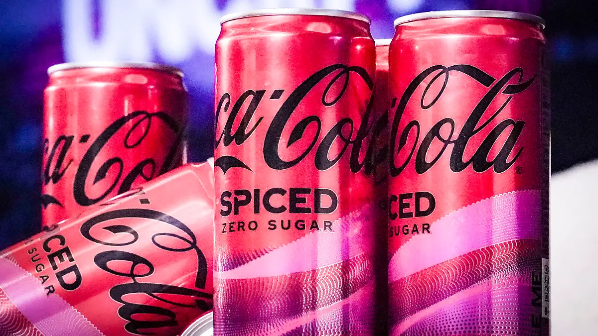 Cans of Coca-Cola Spiced, the beverage company's first new permanent offering to its North American portfolio in three years, are introduced at a livestream media event, Tuesday, Feb. 6, 2024, in New York. (AP Photo/Bebeto Matthews)