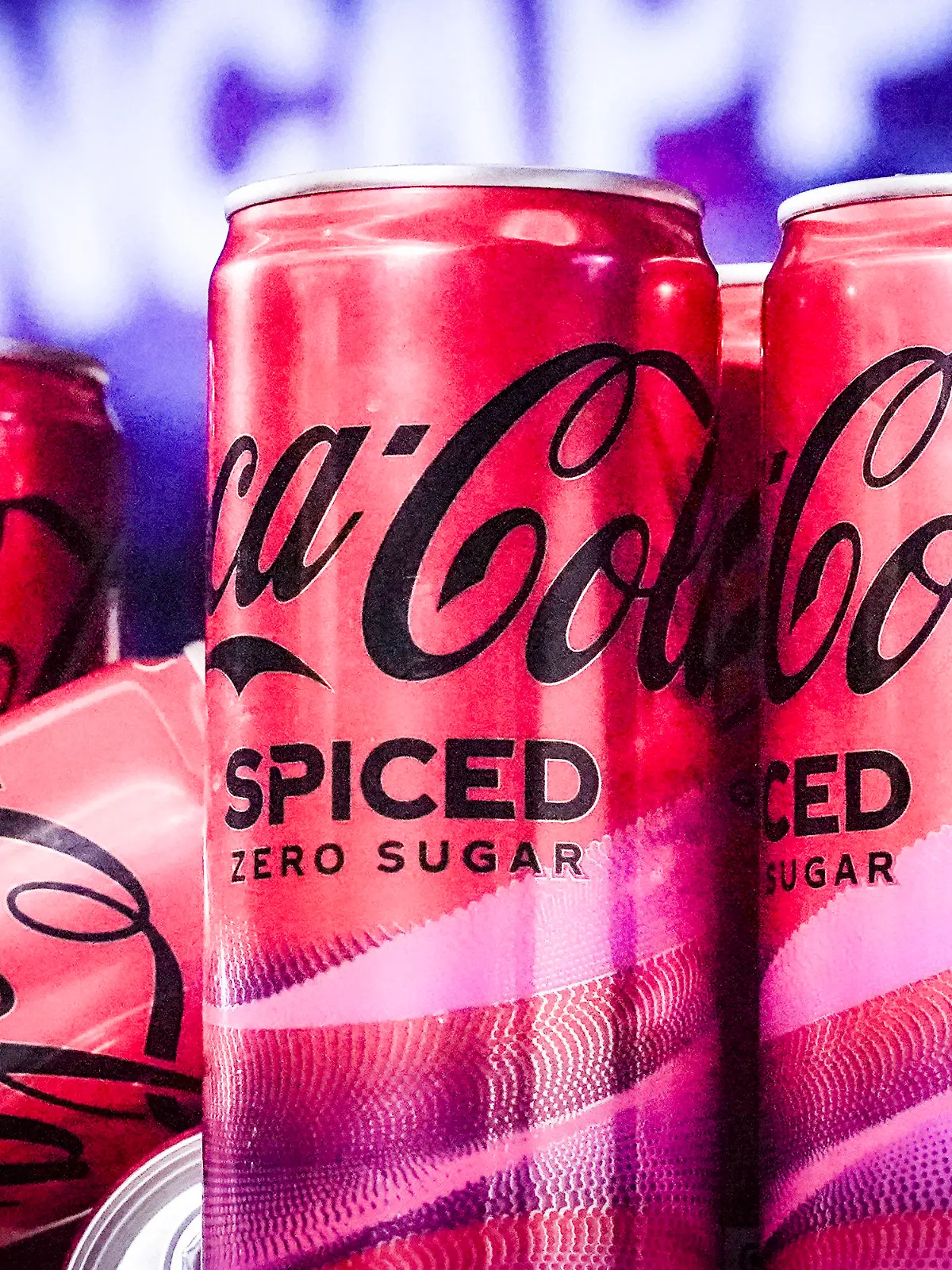 Cans of Coca-Cola Spiced, the beverage company's first new permanent offering to its North American portfolio in three years, are introduced at a livestream media event, Tuesday, Feb. 6, 2024, in New York. (AP Photo/Bebeto Matthews)