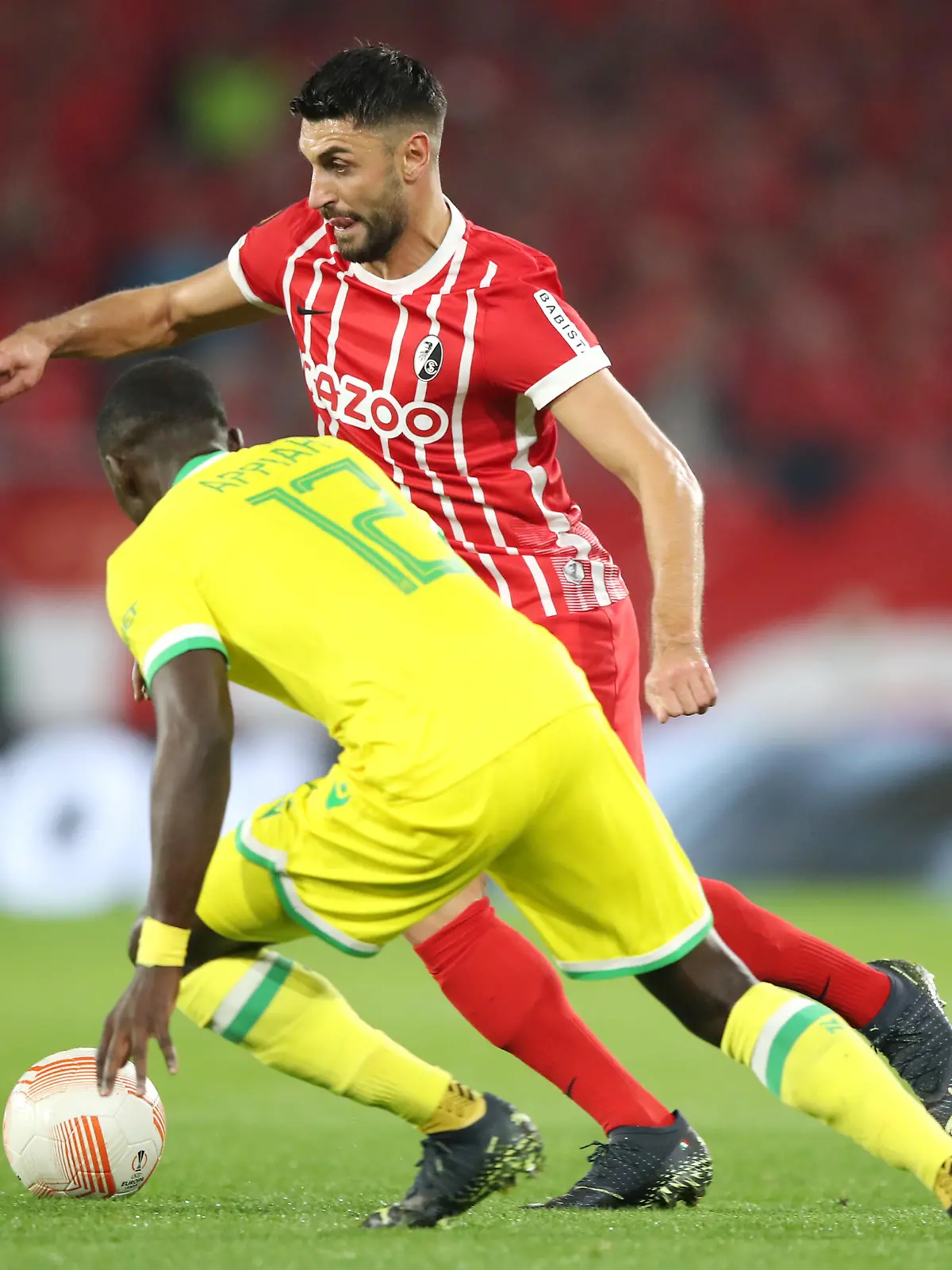 FREIBURG IM BREISGAU, GERMANY - OCTOBER 06: Vincenzo Grifo of SC Freiburg is challenged by Dennis Appiah of FC Nantes during the UEFA Europa League group G match between Sport-Club Freiburg and FC Nantes at Stadion am Wolfswinkel on October 06, 2022 in Freiburg im Breisgau, Germany. (Photo by Christian Kaspar-Bartke/Getty Images)