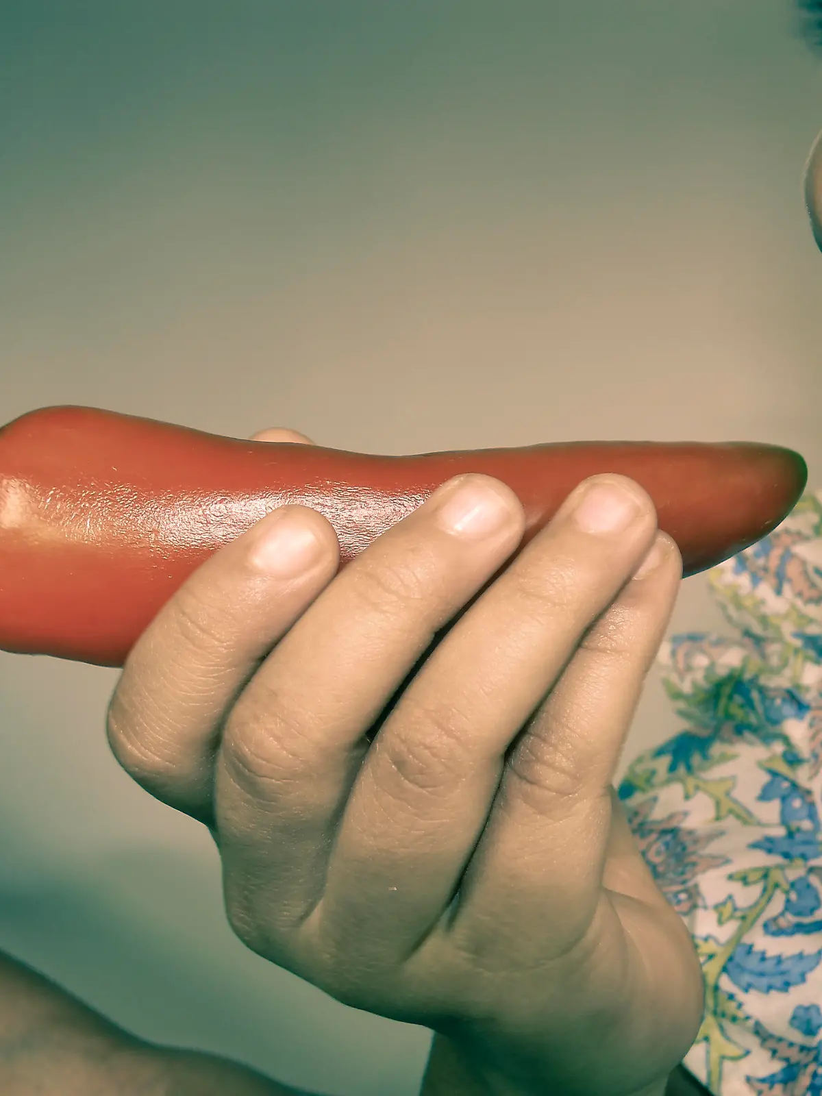 Small Girl holding chili in her mouth