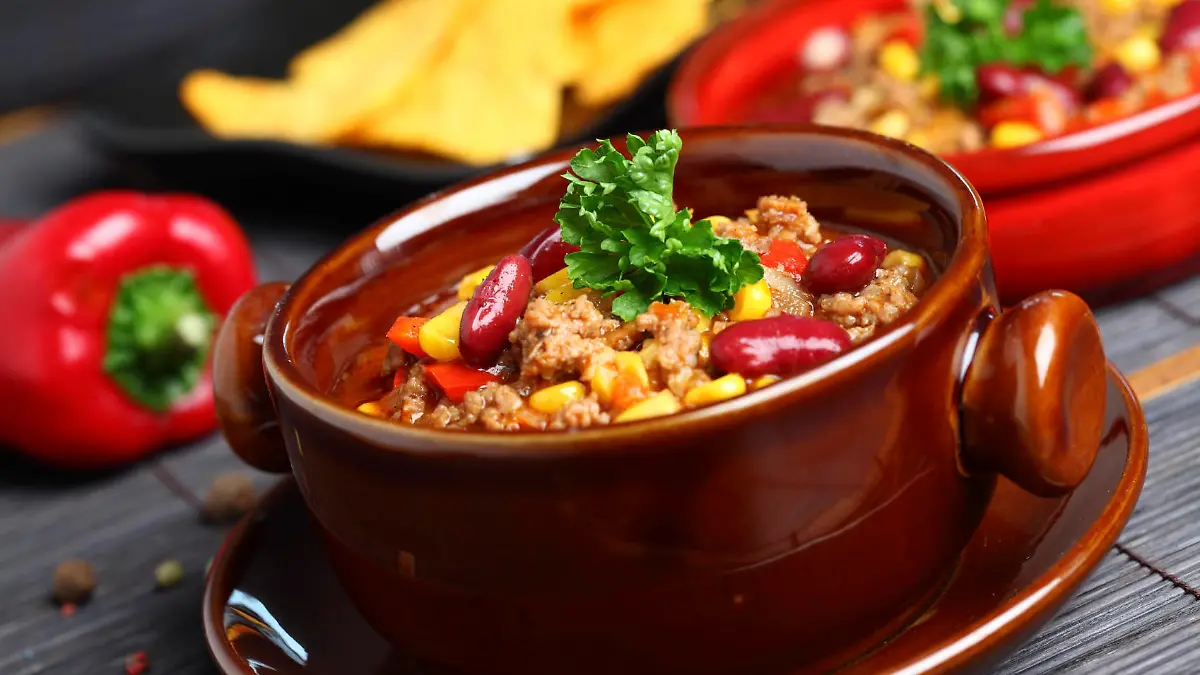 Bowl of chili with peppers and beans