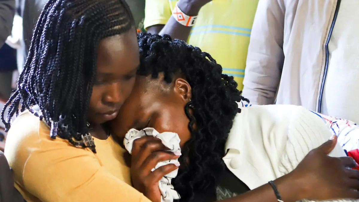 Asenath Rotich, widow of Kenya's marathon world record holder Kelvin Kiptum, who died in a road accident, reacts after viewing his body, in Chepkorio village, Elgeyo-Marakwet County, Kenya February 22, 2024. REUTERS/Stringer NO RESALES. NO ARCHIVES
