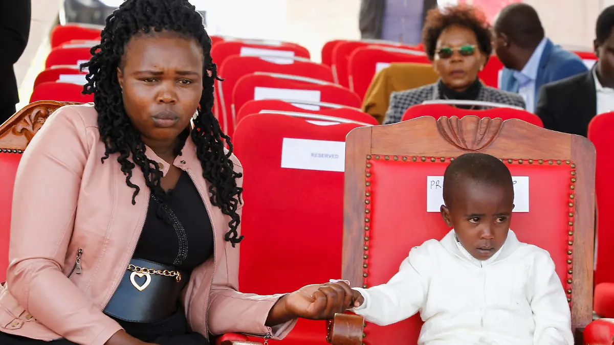 Asenath Rotich, a widow of the of Kenya's marathon world record holder Kelvin Kiptum, who died in a road accident, and her daughter Precious sit during his funeral service at Chepkorio show ground, Elgeyo Marakwet County, Kenya February 23, 2024. REUTERS/Monicah Mwangi