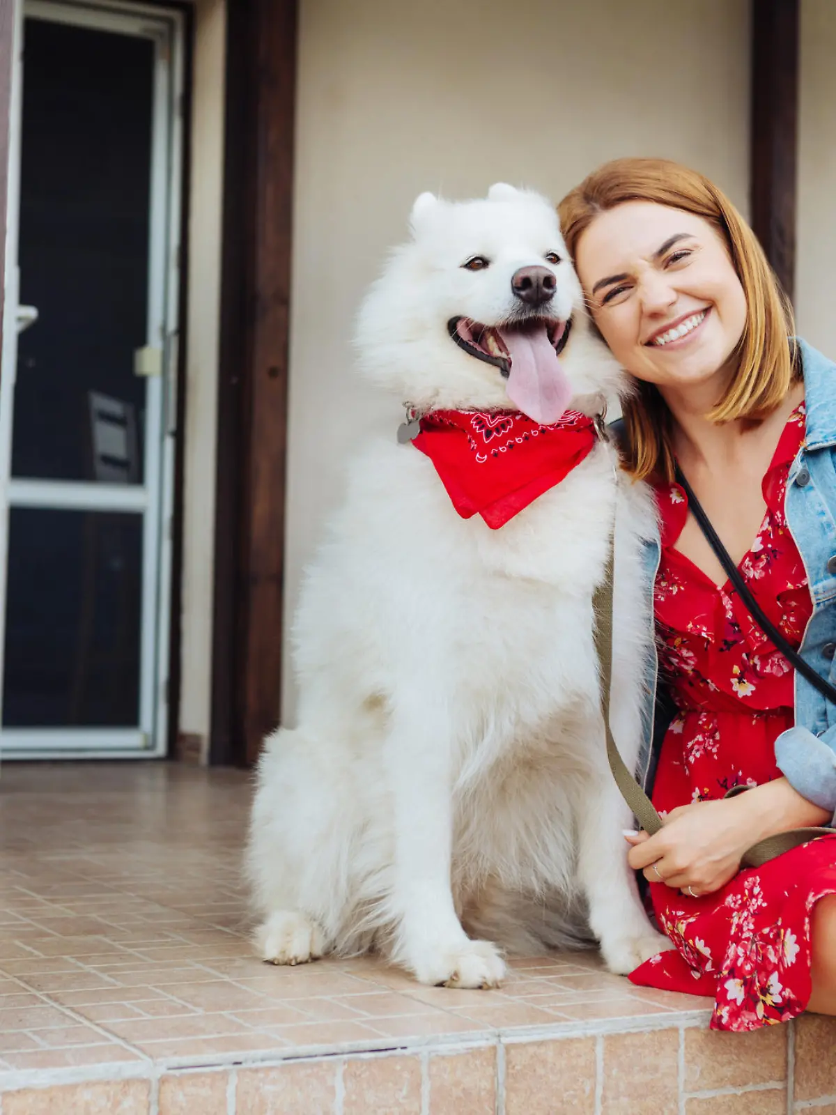 Woman with dog. Beaming fashionable woman feeling excited while coming to summer house with her dog