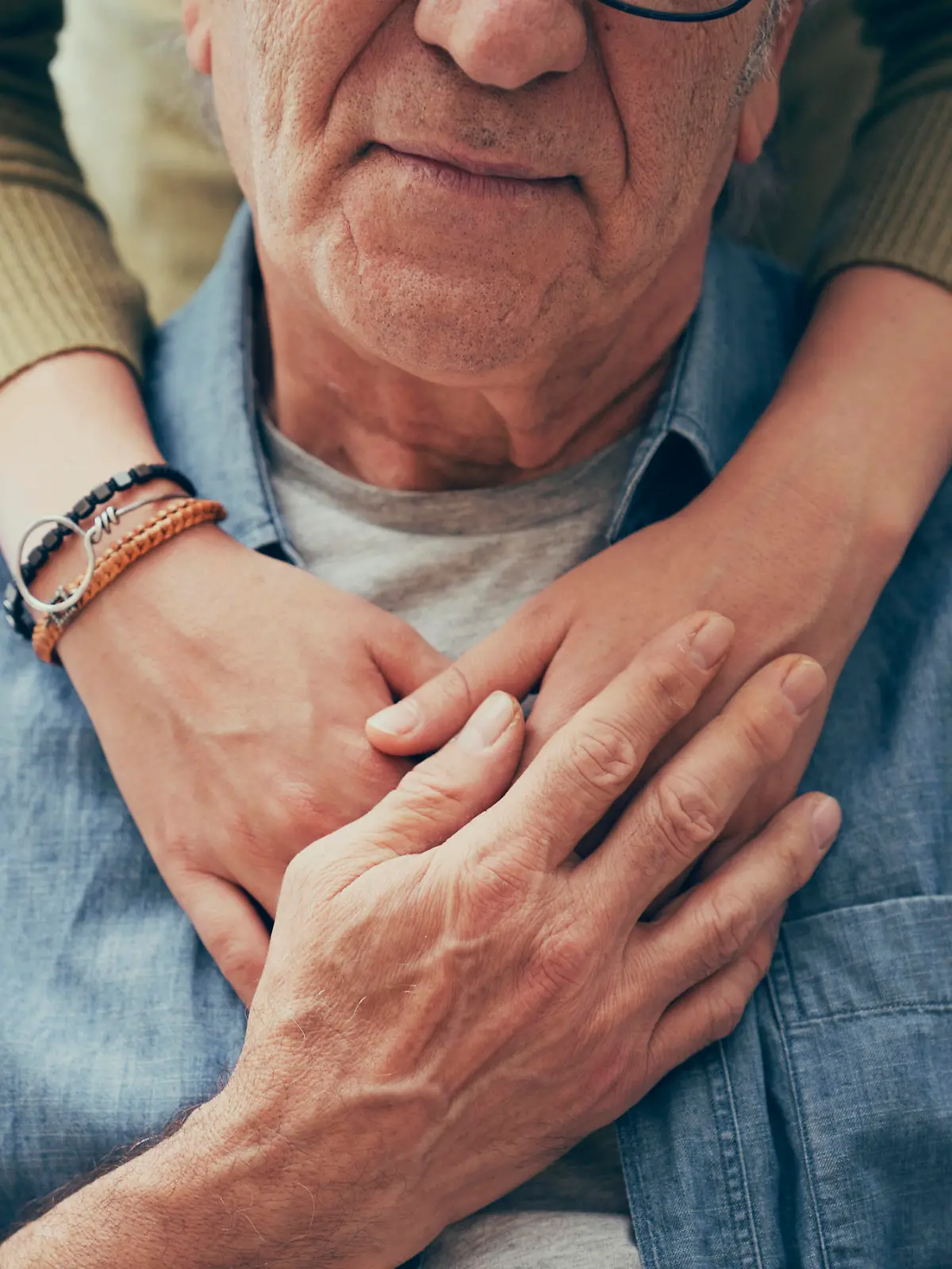 Comforting hand on shoulder of man