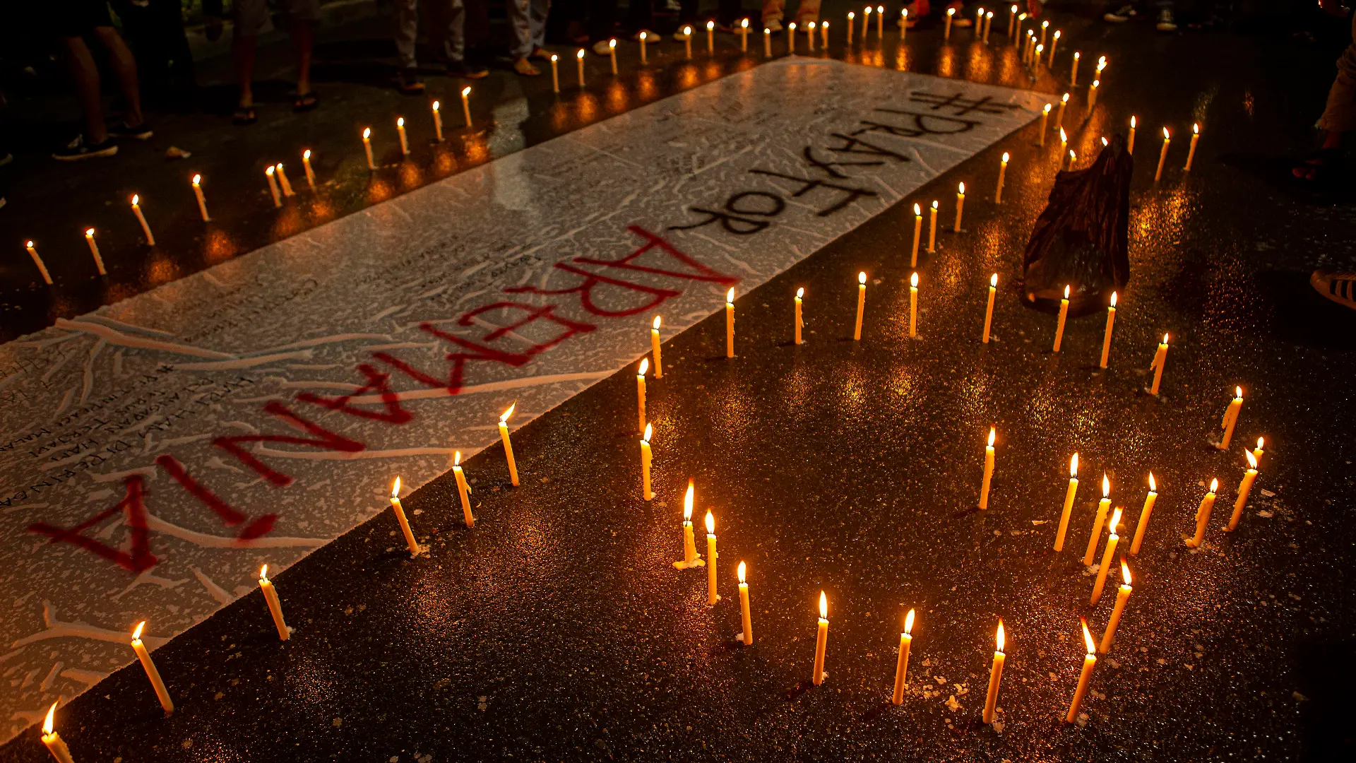 Tragedy of 125 Football Supporters Killed in Indonesia A number of soccer supporters burn candles and place them around banners during a peaceful protest in Palu City, Central Sulawesi Province, Indonesia, Monday, October 3, 2022. This peaceful demonstration is a sign of mourning over the tragedy of the death of 125 football supporters at the Kanjuruhan stadium in Malang, East Java. after the Arema derby against Persebaya, Saturday 1 October 2022. PUBLICATIONxNOTxINxINA Copyright: xOpanxBustanx/xOpnxImagesx