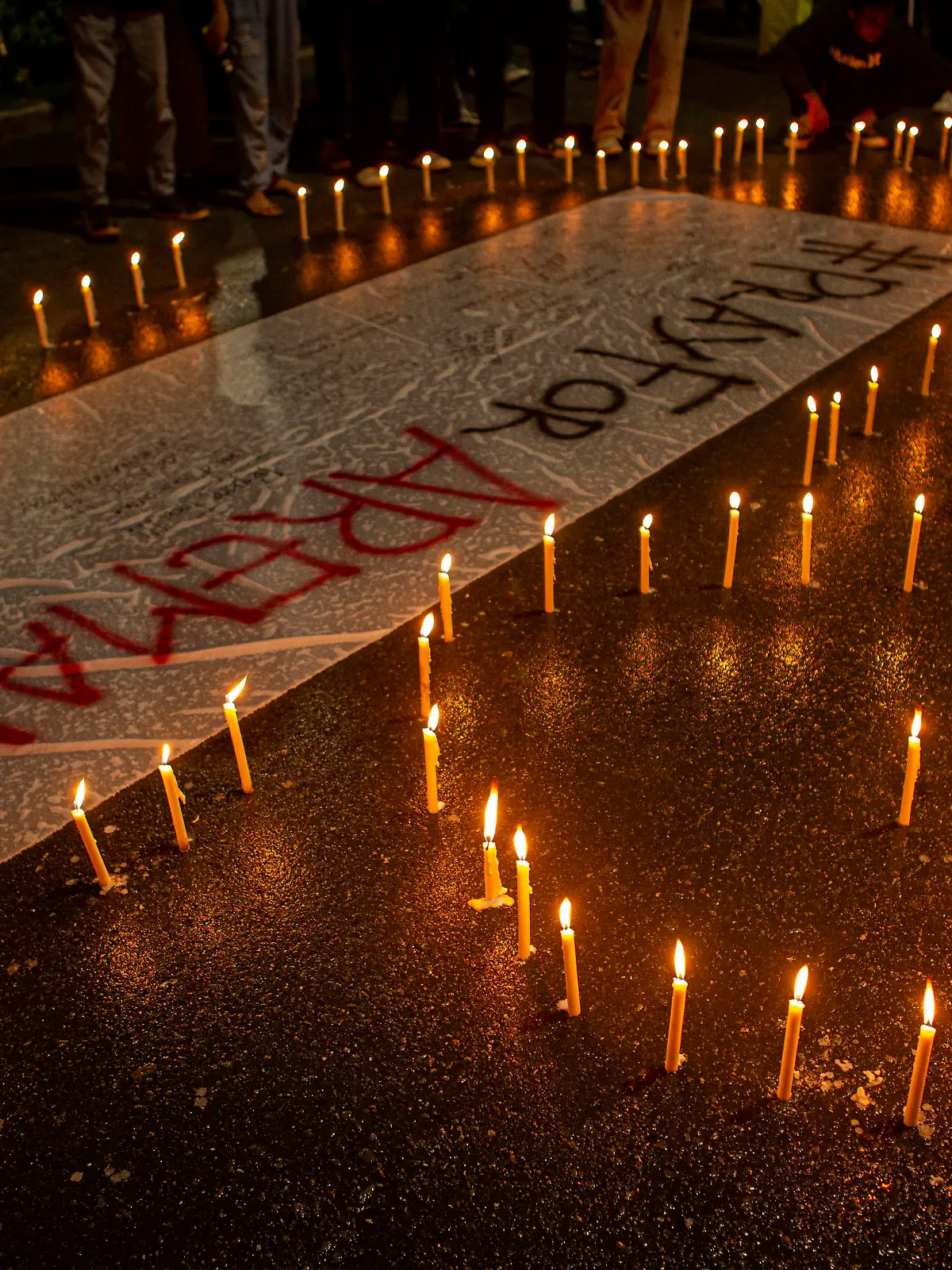 Tragedy of 125 Football Supporters Killed in Indonesia A number of soccer supporters burn candles and place them around banners during a peaceful protest in Palu City, Central Sulawesi Province, Indonesia, Monday, October 3, 2022. This peaceful demonstration is a sign of mourning over the tragedy of the death of 125 football supporters at the Kanjuruhan stadium in Malang, East Java. after the Arema derby against Persebaya, Saturday 1 October 2022. PUBLICATIONxNOTxINxINA Copyright: xOpanxBustanx/xOpnxImagesx