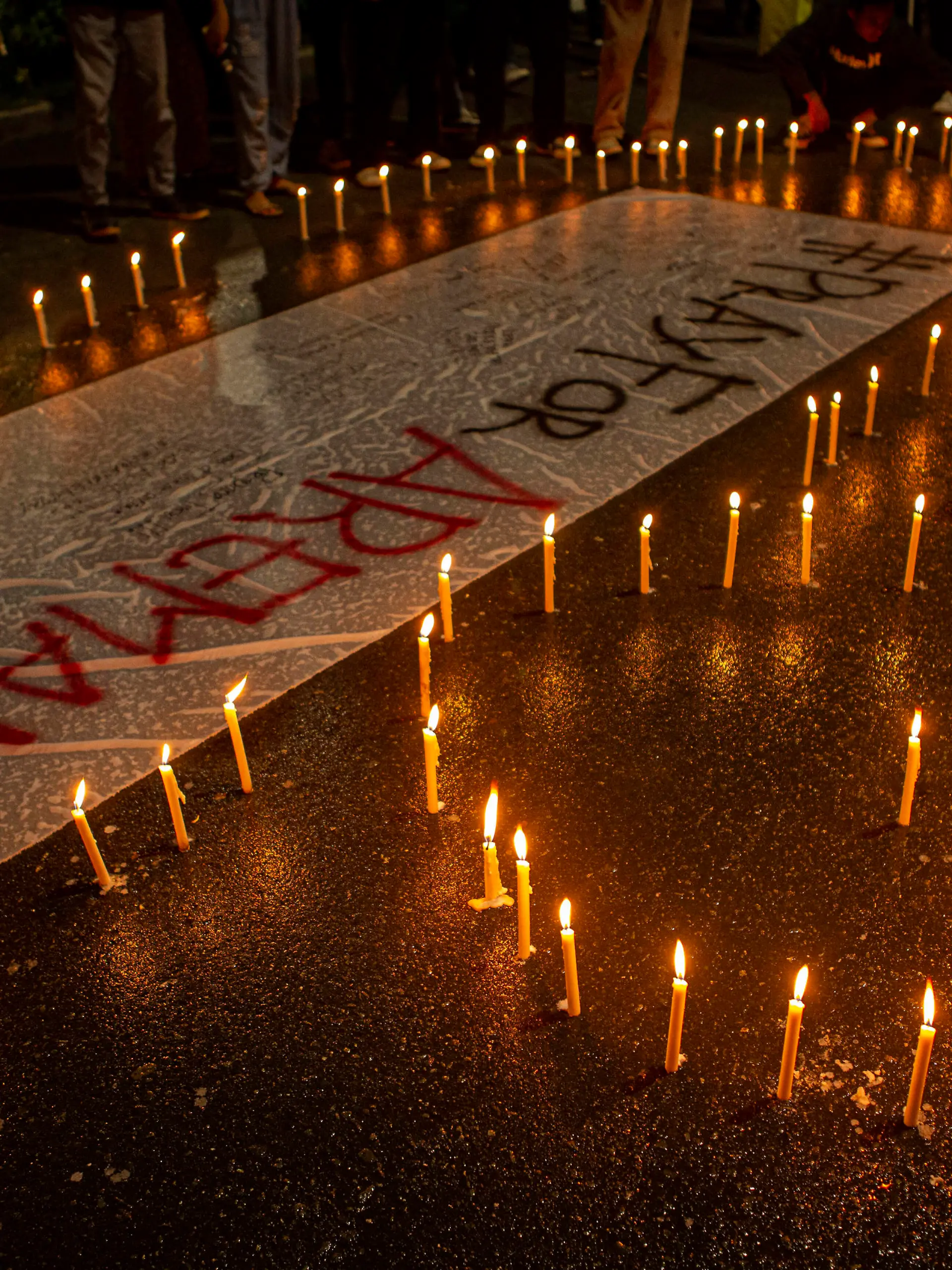  Tragedy of 125 Football Supporters Killed in Indonesia A number of soccer supporters burn candles and place them around banners during a peaceful protest in Palu City, Central Sulawesi Province, Indonesia, Monday, October 3, 2022. This peaceful demonstration is a sign of mourning over the tragedy of the death of 125 football supporters at the Kanjuruhan stadium in Malang, East Java. after the Arema derby against Persebaya, Saturday 1 October 2022. PUBLICATIONxNOTxINxINA Copyright: xOpanxBustanx/xOpnxImagesx