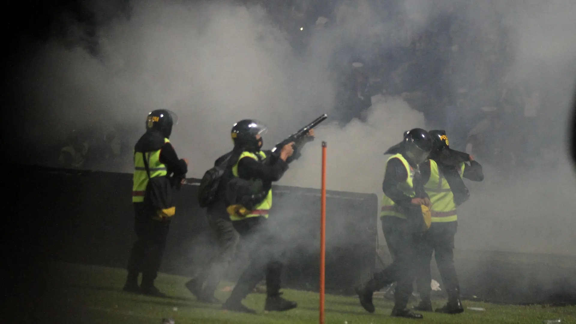 A riot police officer fires tear gas during a riot after the league BRI Liga 1 football match between Arema vs Persebaya at Kanjuruhan Stadium in Malang, East Java province, Indonesia, October 2, 2022, in this photo taken by Antara Foto. Antara Foto/Ari Bowo Sucipto/via REUTERS ATTENTION EDITORS - THIS IMAGE HAS BEEN SUPPLIED BY A THIRD PARTY. MANDATORY CREDIT. INDONESIA OUT. NO COMMERCIAL OR EDITORIAL SALES IN INDONESIA.