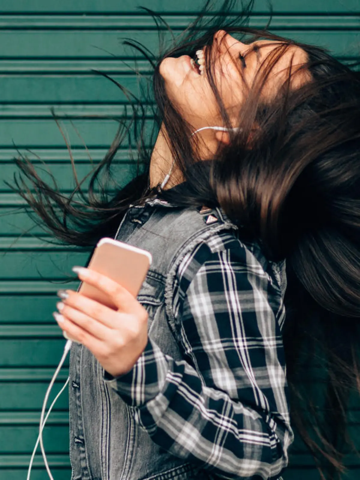 Young woman tossing hair while enjoying the music