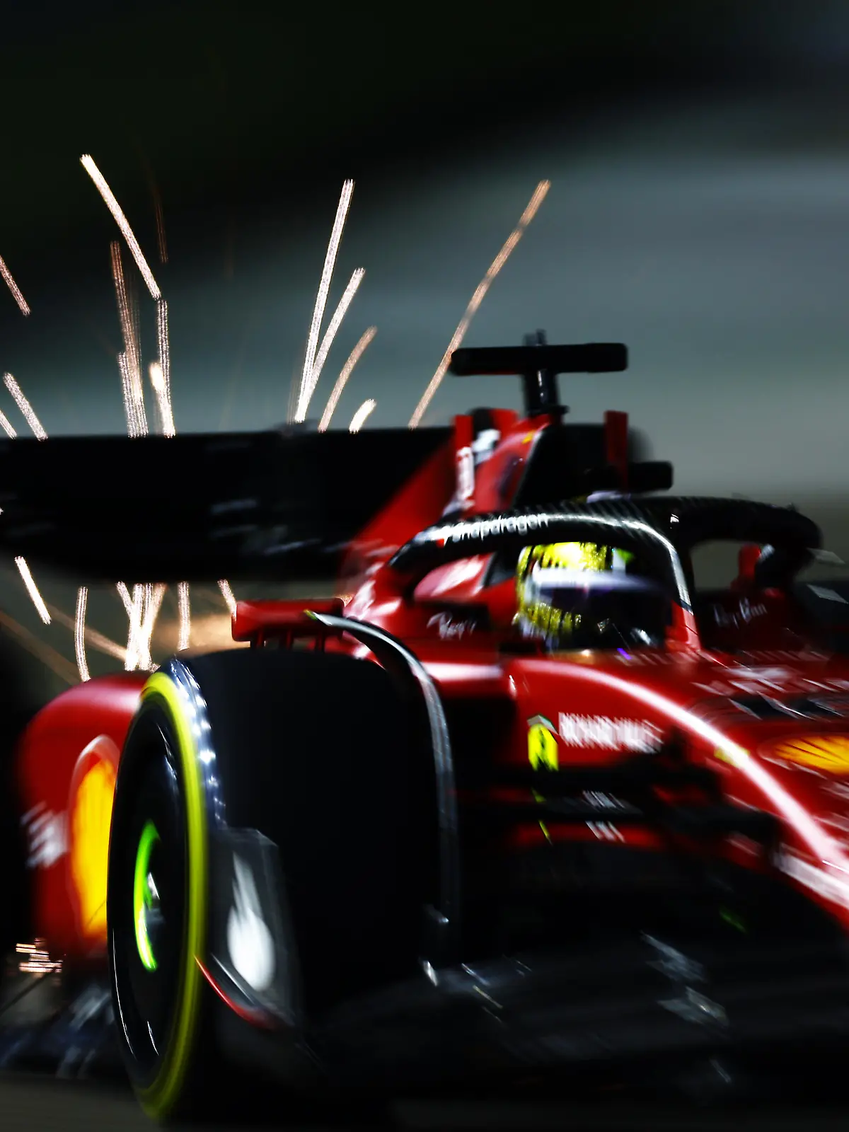 SINGAPORE, SINGAPORE - SEPTEMBER 30: Sparks fly behind Charles Leclerc of Monaco driving the (16) Ferrari F1-75 on track during practice ahead of the F1 Grand Prix of Singapore at Marina Bay Street Circuit on September 30, 2022 in Singapore, Singapore. (Photo by Mark Thompson/Getty Images,)