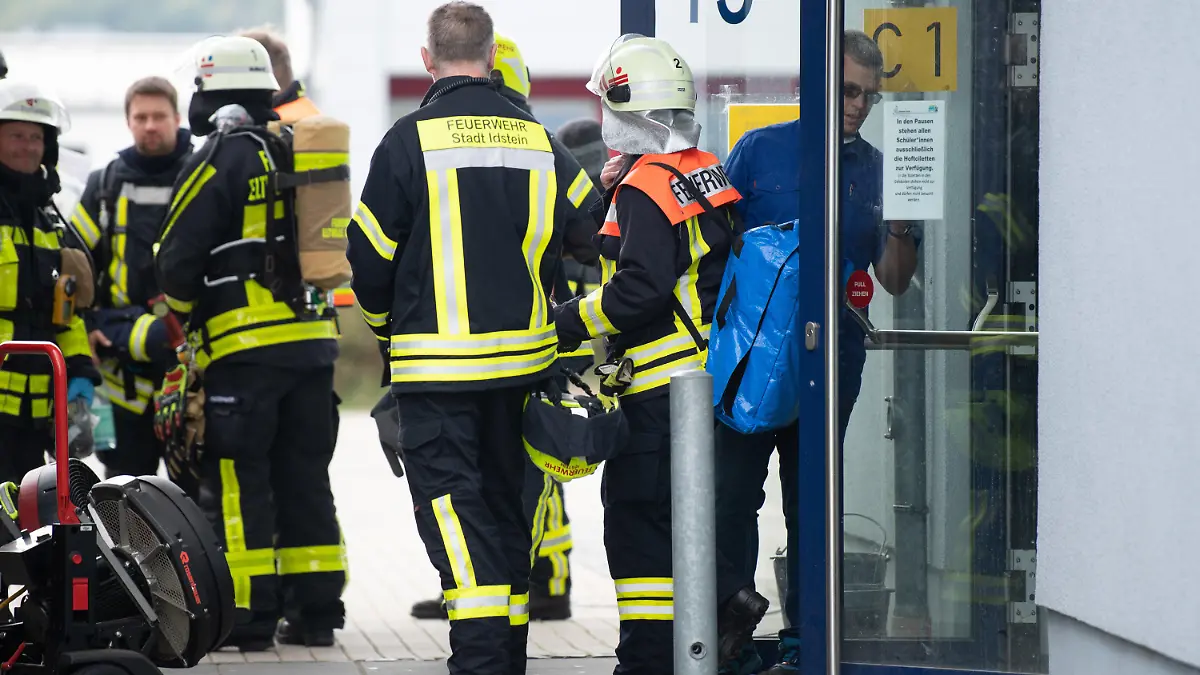29.09.2022, Hessen, Idstein: Einsatzkräfte der Feuerwehr kommen nach einem Gasaustritt an der Limesschule aus dem betroffenen Gebäudeteil. In der Schule wurden durch ein unbekanntes Gas mehrere Schüler und Schülerinnen leicht verletzt und im Krankenhaus behandelt. Foto: Sebastian Gollnow/dpa +++ dpa-Bildfunk +++