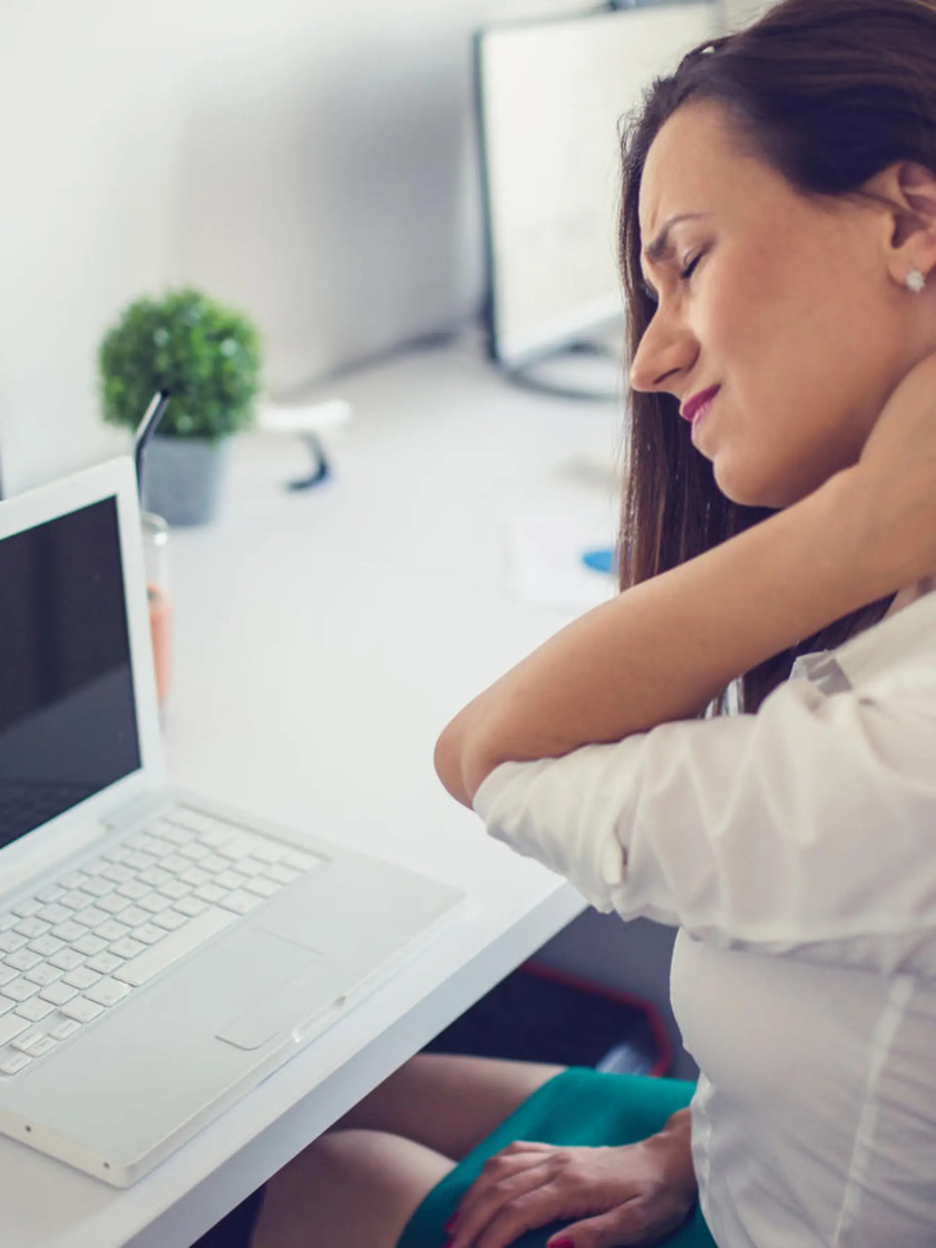 Businesswoman having pain in her neck,Neck pain at work