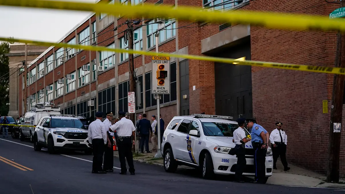 Investigators work the scene where multiple people were shot near a high school in Philadelphia, Tuesday, Sept. 27, 2022. (AP Photo/Matt Slocum)