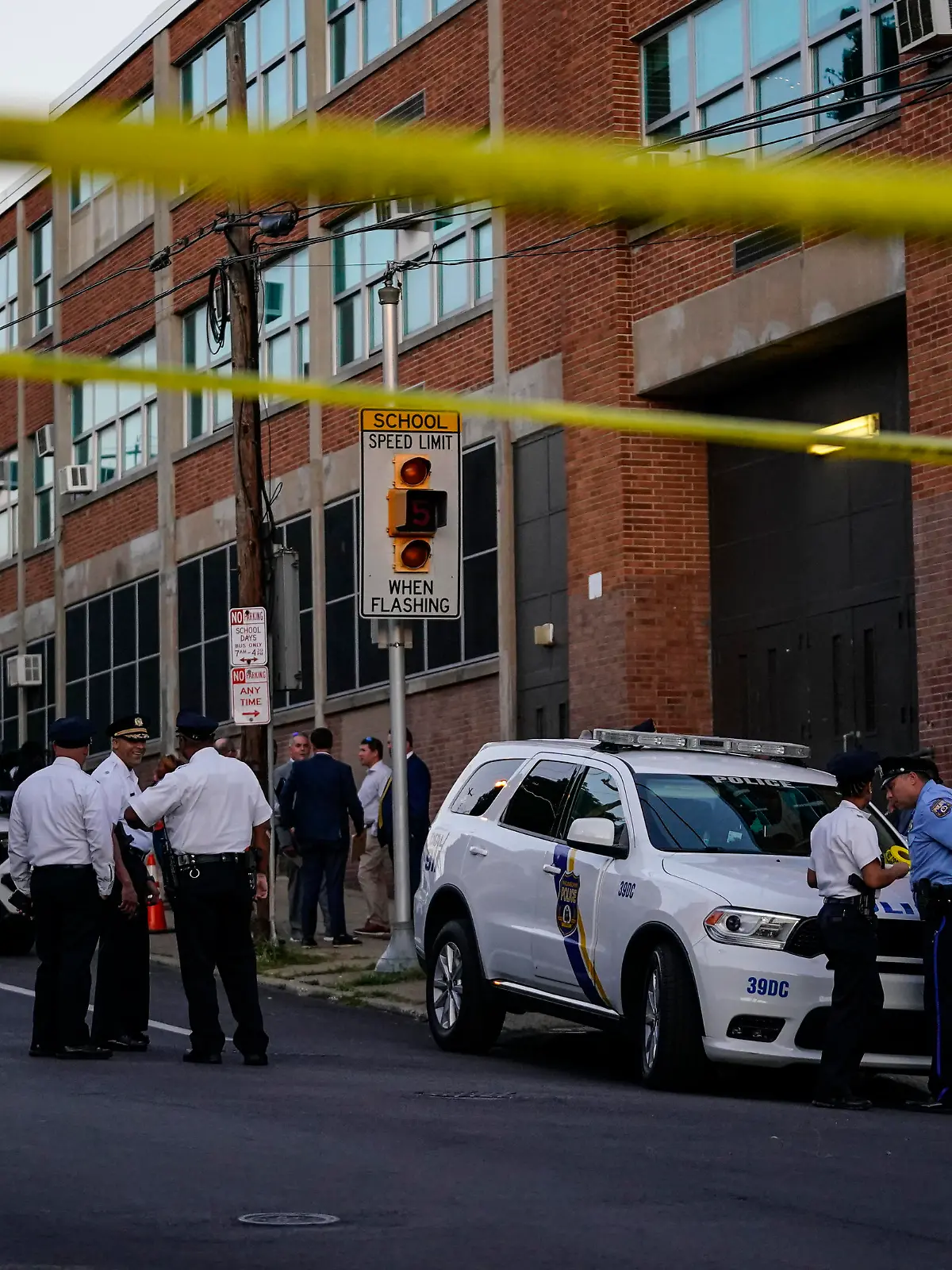 Investigators work the scene where multiple people were shot near a high school in Philadelphia, Tuesday, Sept. 27, 2022. (AP Photo/Matt Slocum)