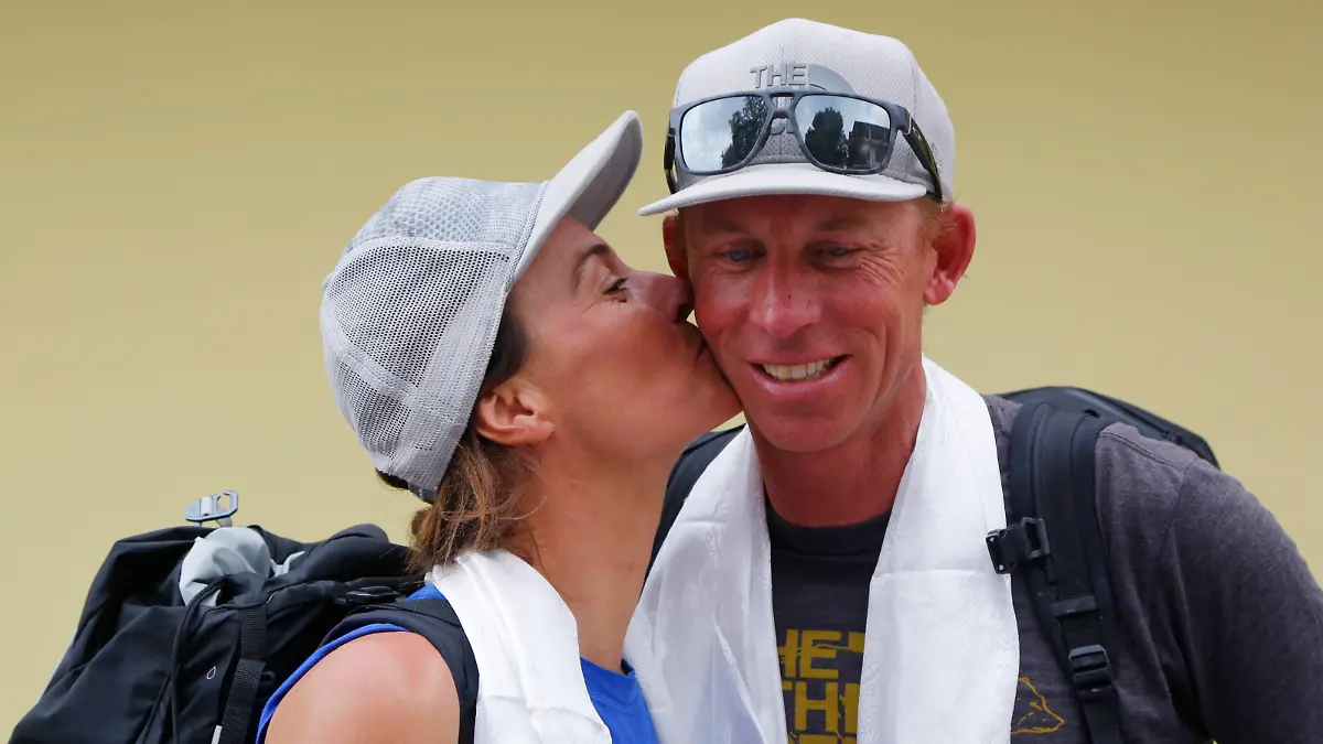 Hilaree Nelson of Telluride, Colorado, kisses James Morrison of Tahoe, California, as the pair arrived in Kathmandu, Nepal, Thursday, Oct. 4, 2018. The two American extreme skiers who overcame weather conditions, delays, equipment and oxygen issues to successfully ski down from the summit of the world's fourth-highest peak Mount Lhotse returned safely from the mountains. (AP Photo/Niranjan Shrestha)