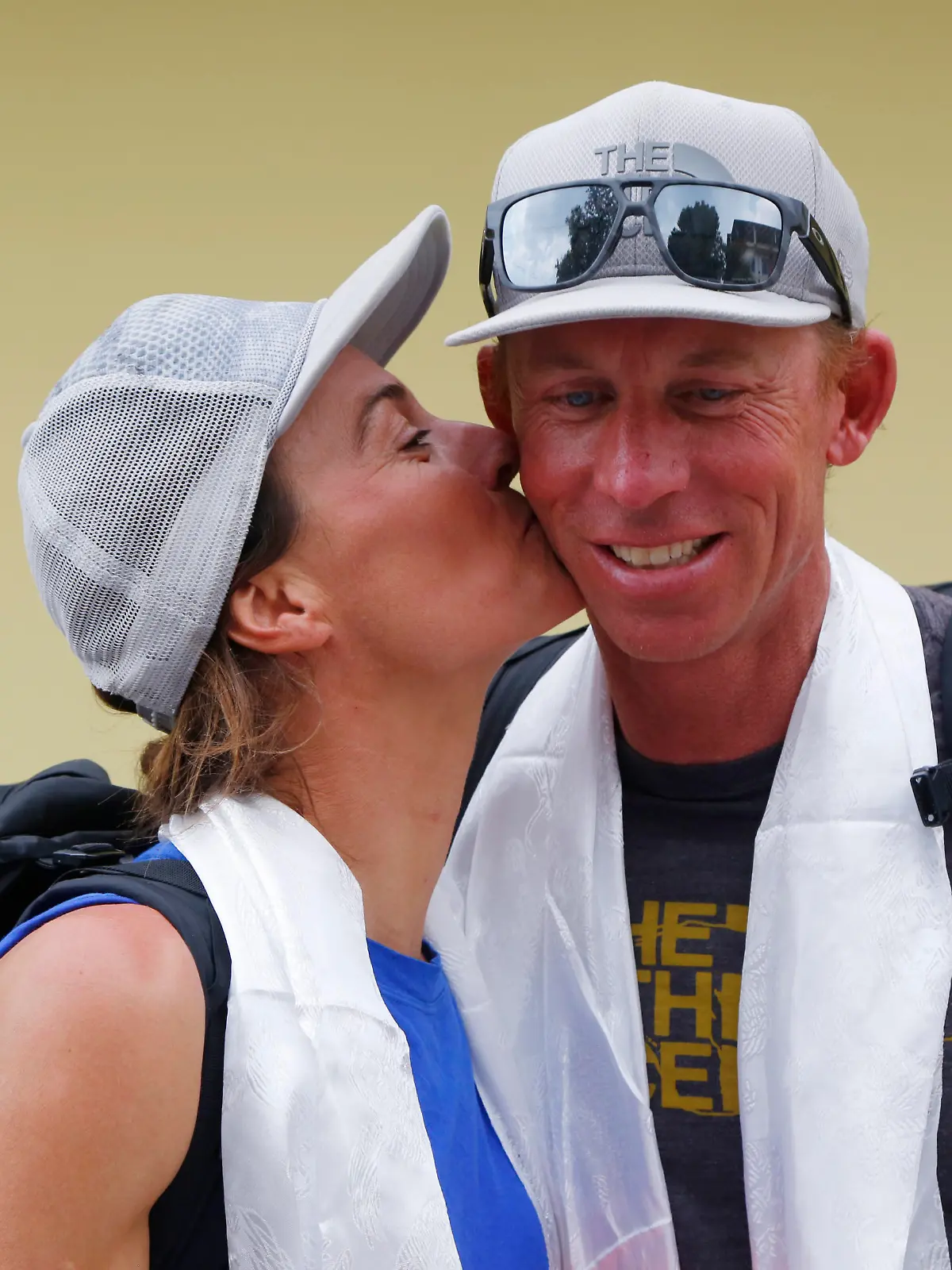 Hilaree Nelson of Telluride, Colorado, kisses James Morrison of Tahoe, California, as the pair arrived in Kathmandu, Nepal, Thursday, Oct. 4, 2018. The two American extreme skiers who overcame weather conditions, delays, equipment and oxygen issues to successfully ski down from the summit of the world's fourth-highest peak Mount Lhotse returned safely from the mountains. (AP Photo/Niranjan Shrestha)