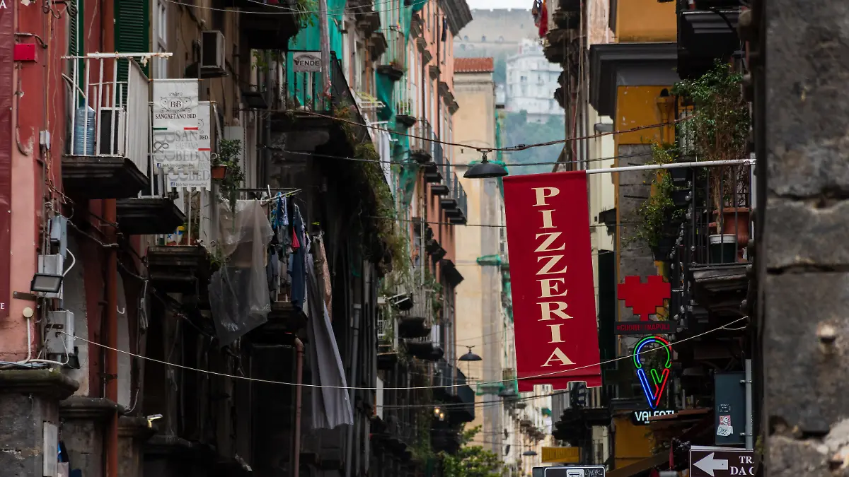 Naples, Italy. May 27, 2022. Red pizzeria sign above the street in Naples, Italy