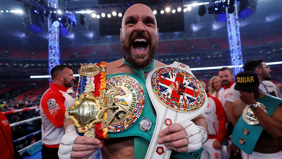 FILE PHOTO: Boxing - Tyson Fury v Dillian Whyte - WBC World Heavyweight Title - Wembley Stadium, London, Britain - April 23, 2022 Tyson Fury celebrates with the belts after winning his fight against Dillian Whyte Action Images via Reuters/Andrew Couldridge/File Photo