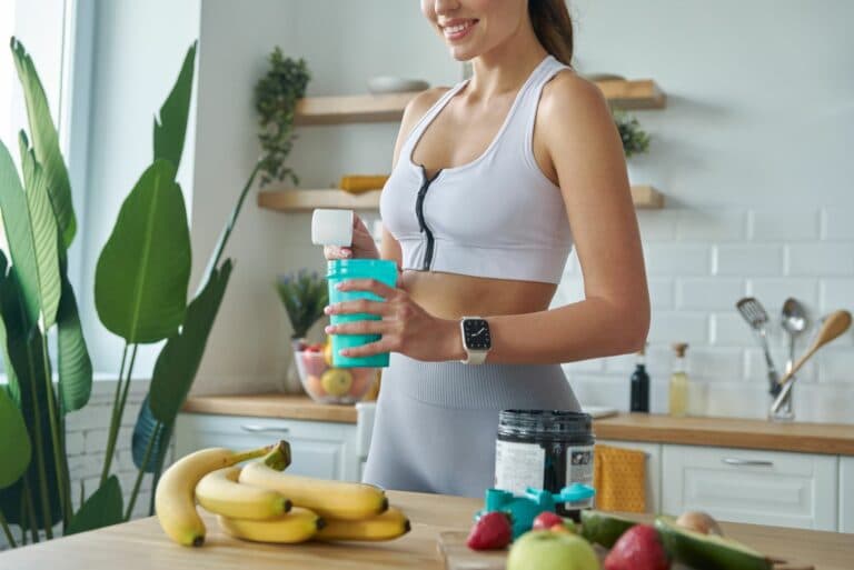 Close-up,Of,Young,Woman,In,Sports,Clothing,Preparing,Protein,Cocktail