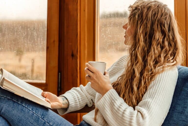 Young,Woman,Reading,Book,And,Drinking,Coffee,Or,Cocoa,At