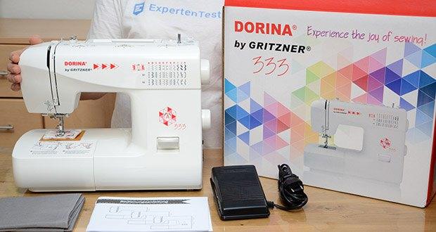 Gritzner Dorina Nähmaschine 333 im Test - Lieferumfang: Anlasser, Deutsche Bedienungsanleitung, Staubschutzhaube, Stoffstück mit Probenähten, Unterschiedliche Nähfüße, Vier Unterfadenspulen, Spulenkapsel, Fläschchen Maschinenöl, Nahttrenner, Minischraubenzieher, Spezialfuß für Knopflochautomatik, Kantenlineal, Großer und kleiner Garnrollenhalter, Zweiter Oberfadenhalter, Drei Ersatznadeln