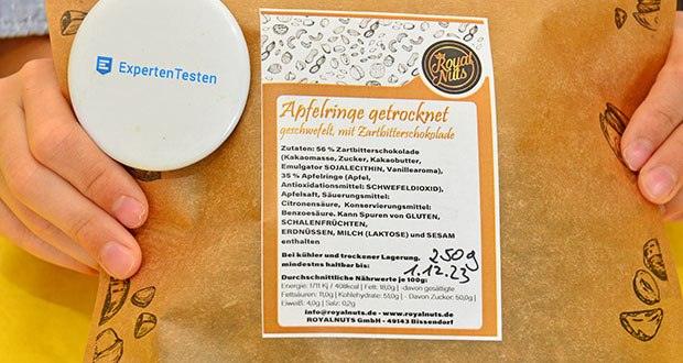 ROYALNUTS Apfelringe mit Zartbitterschokolade im Test - Zutaten: Apfelringe getrocknet, geschwefelt und mit Zartbitterschokolade 56 % Zartbitterschokolade, 35 % Apfelringe, Apfelsaft, Säuerungsmittel: Citronensäure, Konservierungsmittel: Benzoesäure